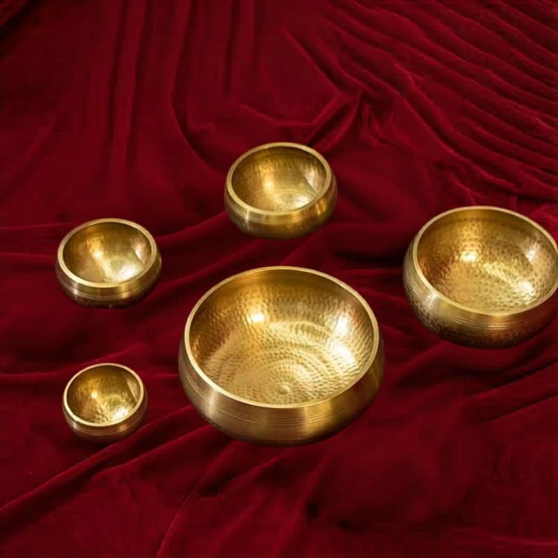 Essentials set of 3 chakra singing bowls with mallets on dark wood